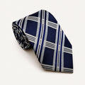 A rolled George Neale navy blue and white plaid silk tie.
