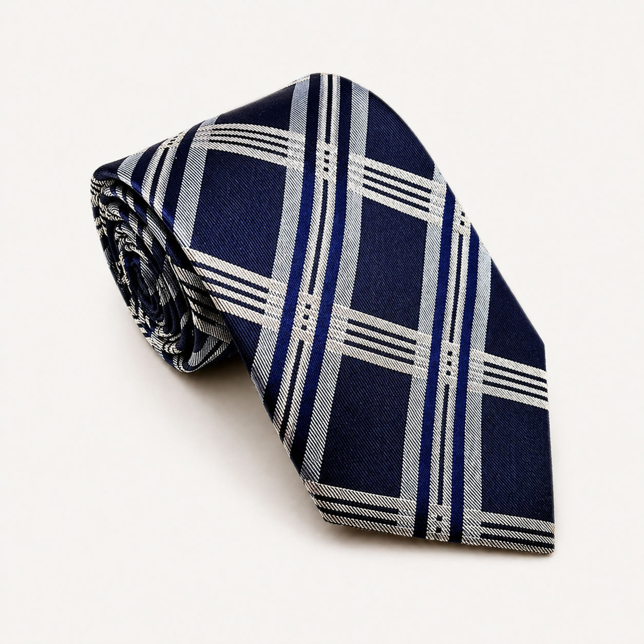 A rolled George Neale navy blue and white plaid silk tie.