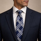 Navy Blue and White Plaid Silk Tie by George Neale, worn by a model with a suit and shirt