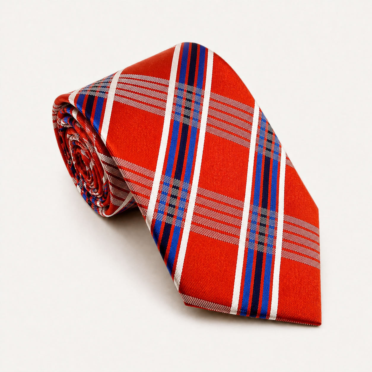 A rolled George Neale orange and blue plaid silk tie.