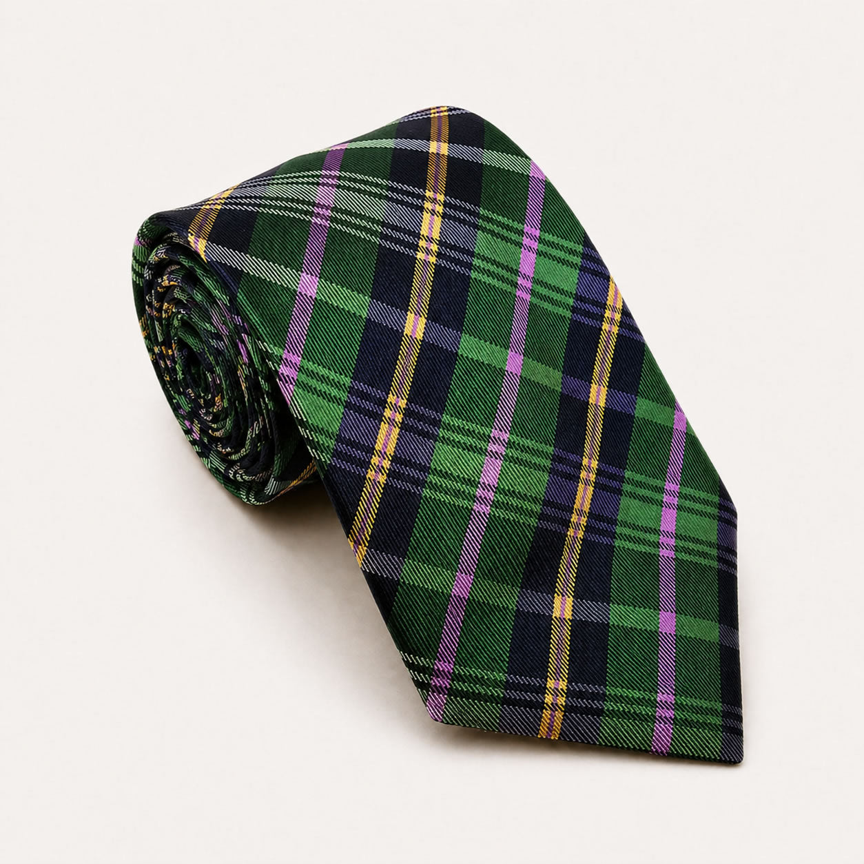 A rolled George Neale green and pink plaid silk tie.
