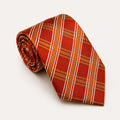 A rolled George Neale orange and gold plaid silk tie.