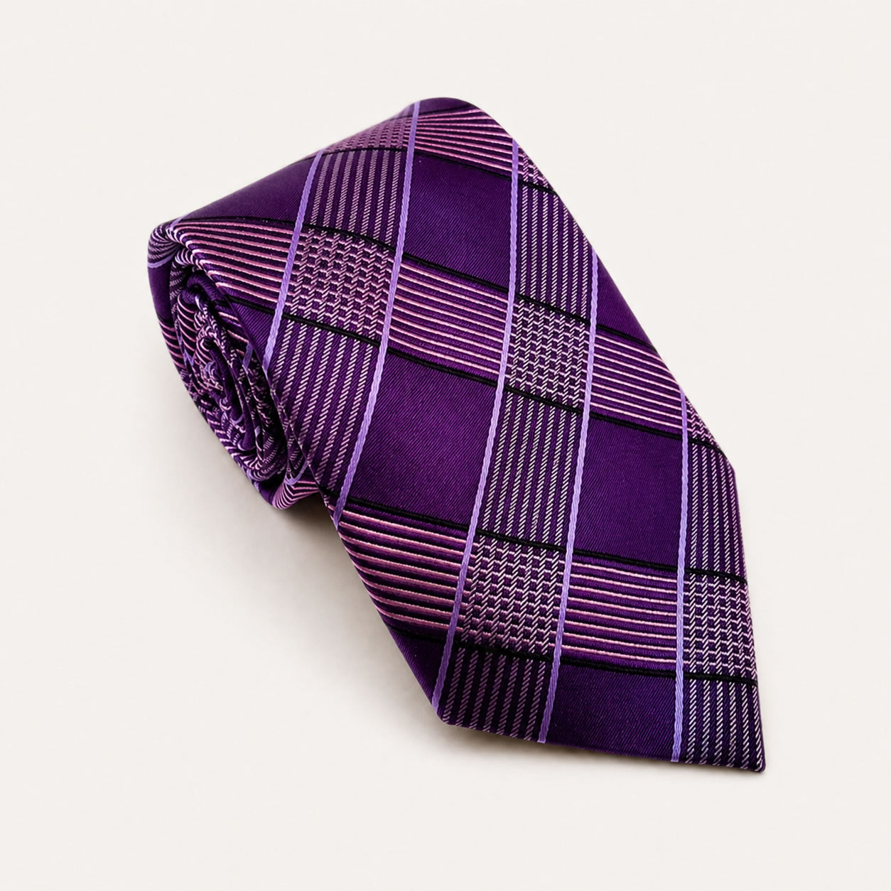 A rolled George Neale purple and lavender plaid silk tie.