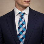 Blue and Silver Plaid Silk Tie by George Neale, worn by a model with a suit and shirt