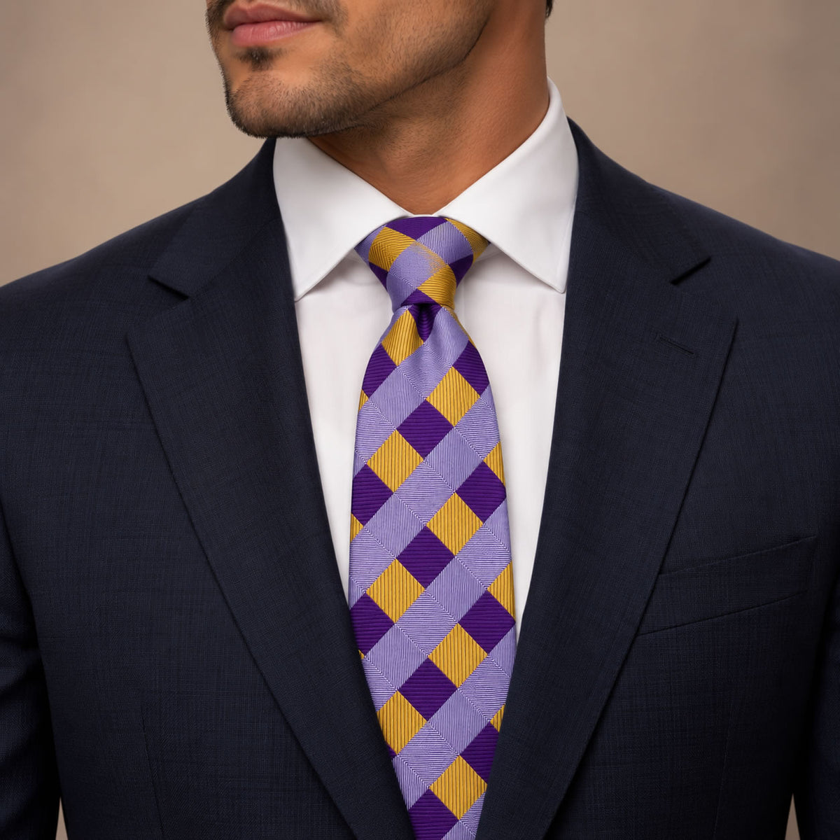 Purple and Gold Plaid Silk Tie by George Neale, worn by a model with a suit and shirt
