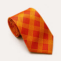 A rolled George Neale orange and gold plaid silk tie.