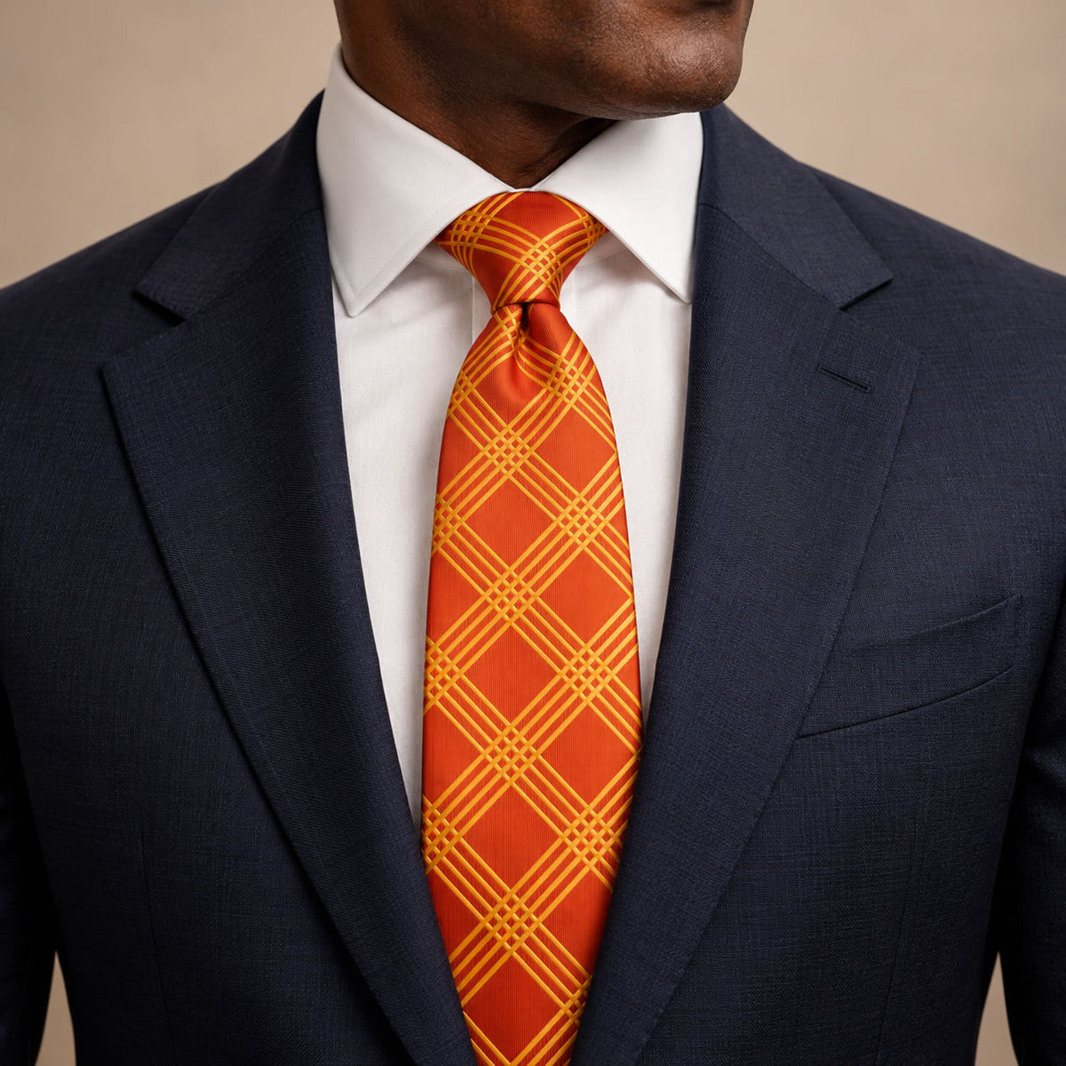 Orange and Gold Plaid Silk Tie by George Neale, worn by a model with a suit and shirt