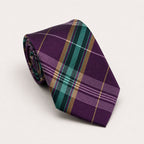 A rolled George Neale purple and green plaid silk tie.