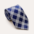 A rolled George Neale navy blue and white plaid silk tie.