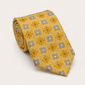 A rolled George Neale gold and blue plaid silk tie.