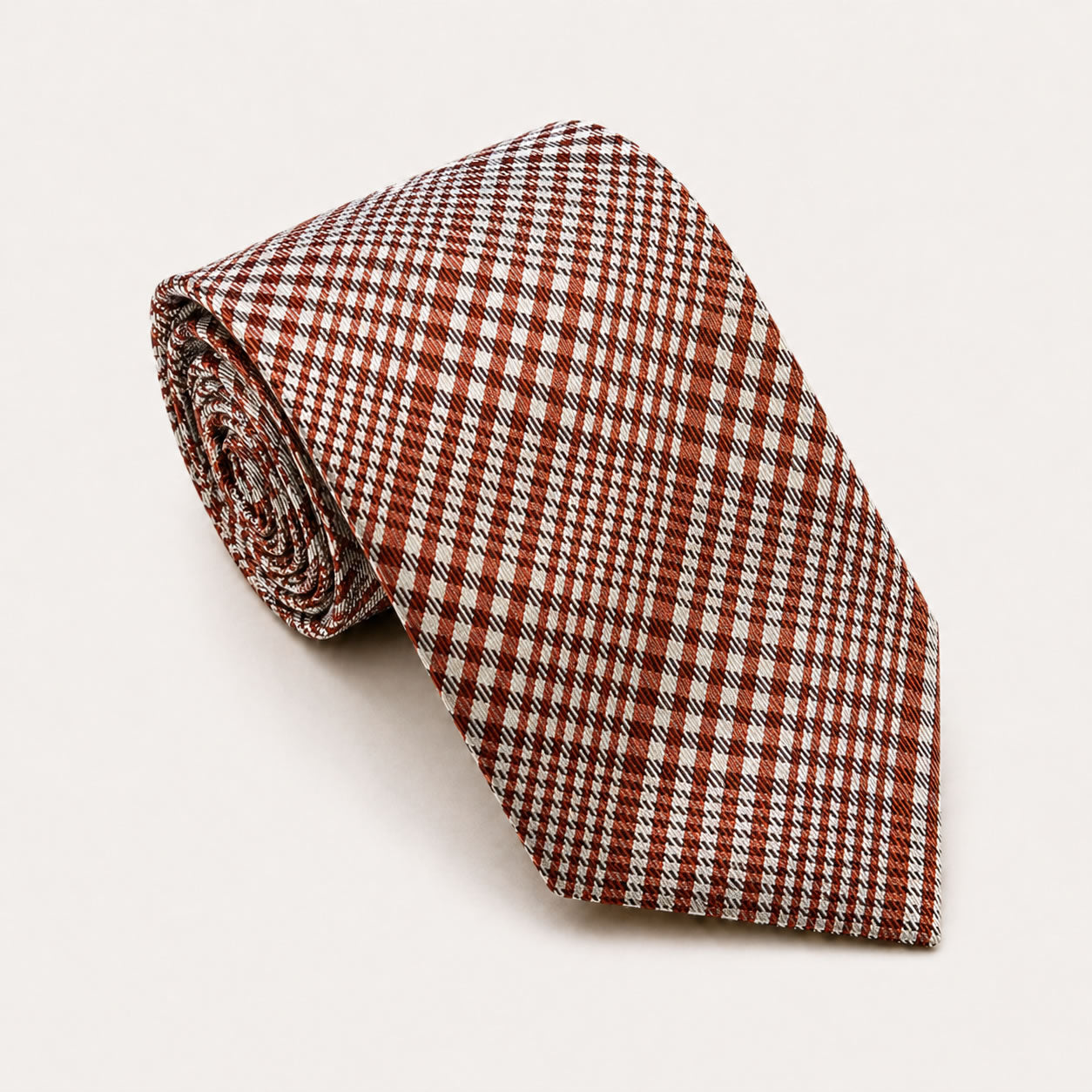 A rolled George Neale rust and white plaid silk tie.
