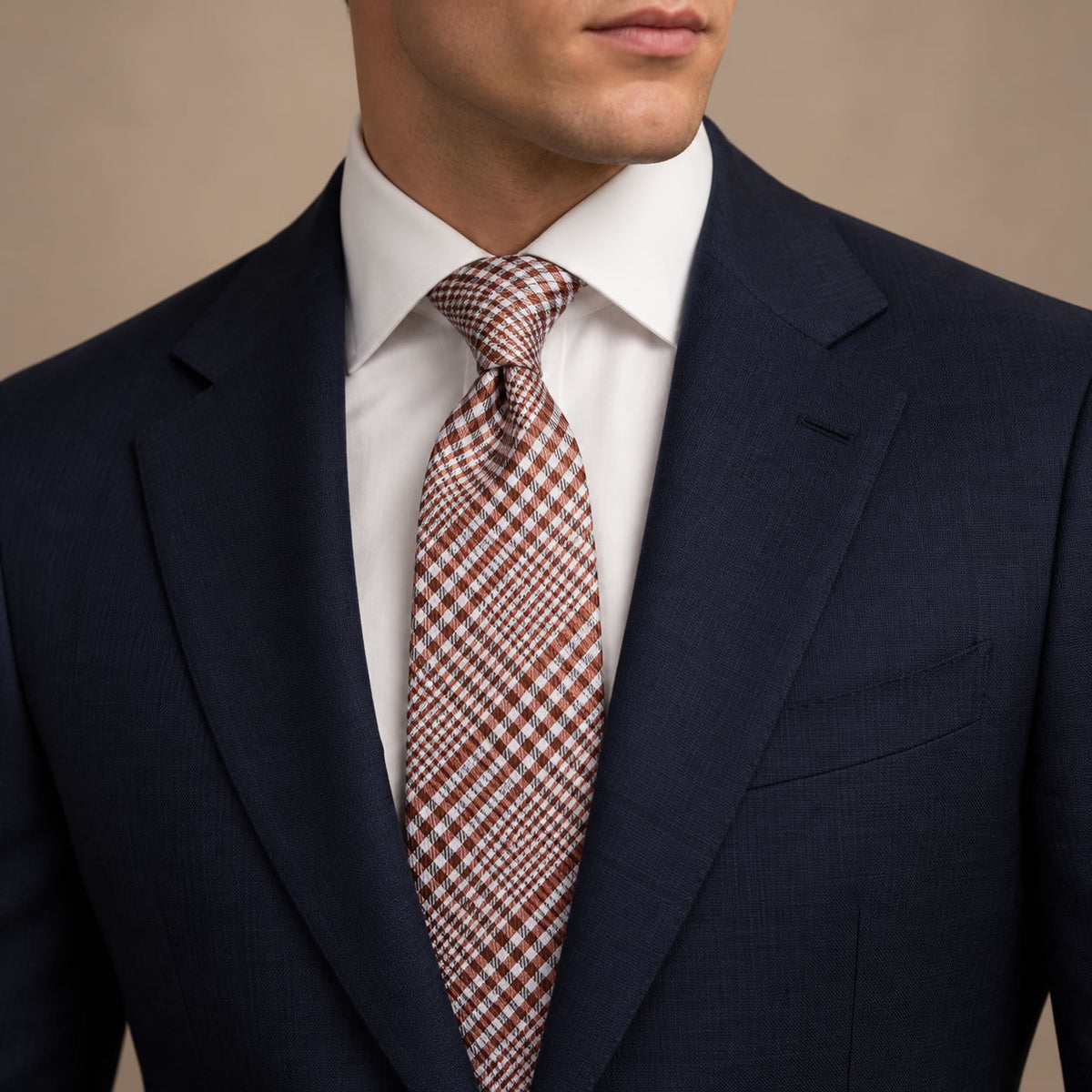 Rust and White Plaid Silk Tie by George Neale, worn by a model with a suit and shirt