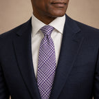 Purple and White Plaid Silk Tie by George Neale, worn by a model with a suit and shirt