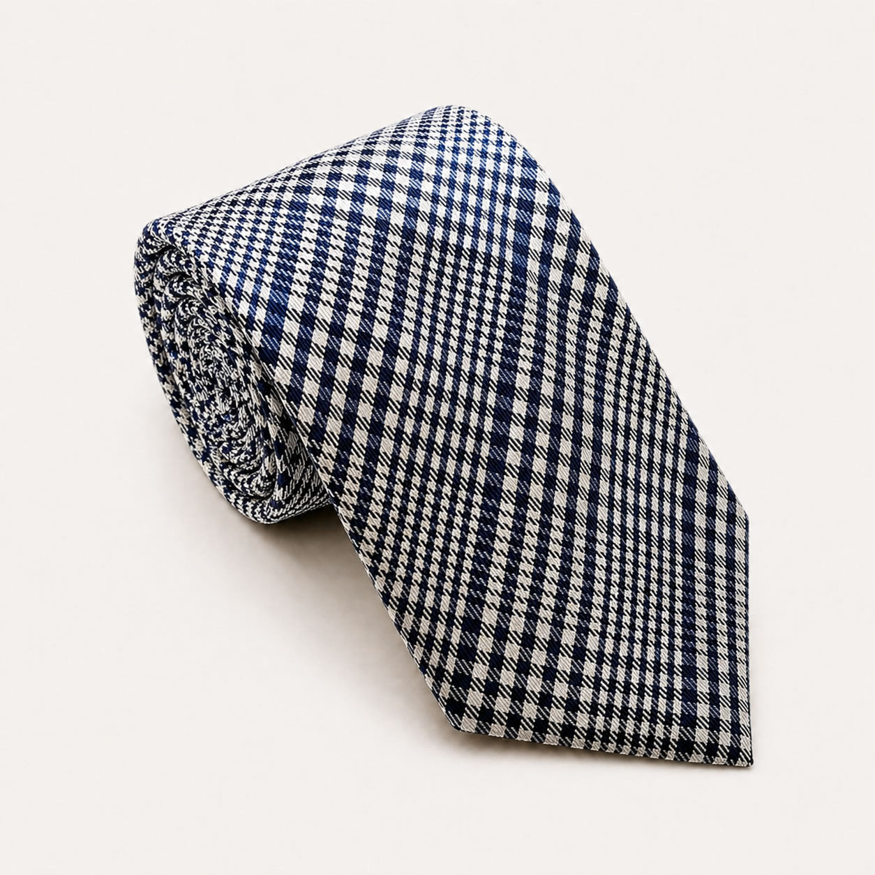 A rolled George Neale navy blue and white plaid silk tie.