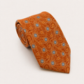 A rolled George Neale burnt orange and blue floral silk tie.
