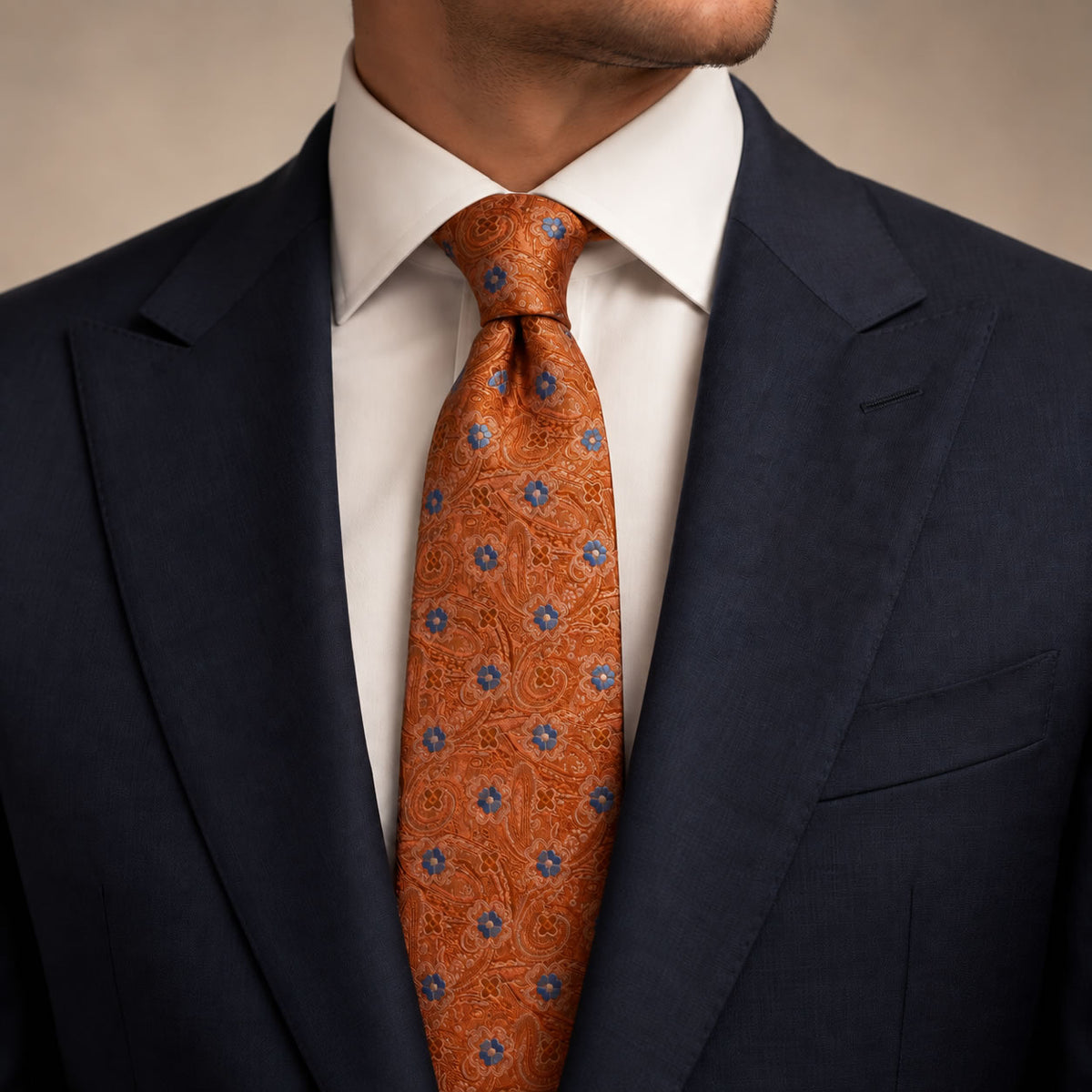 Burnt Orange and Blue Floral Silk Tie by George Neale, worn by a model with a suit and shirt