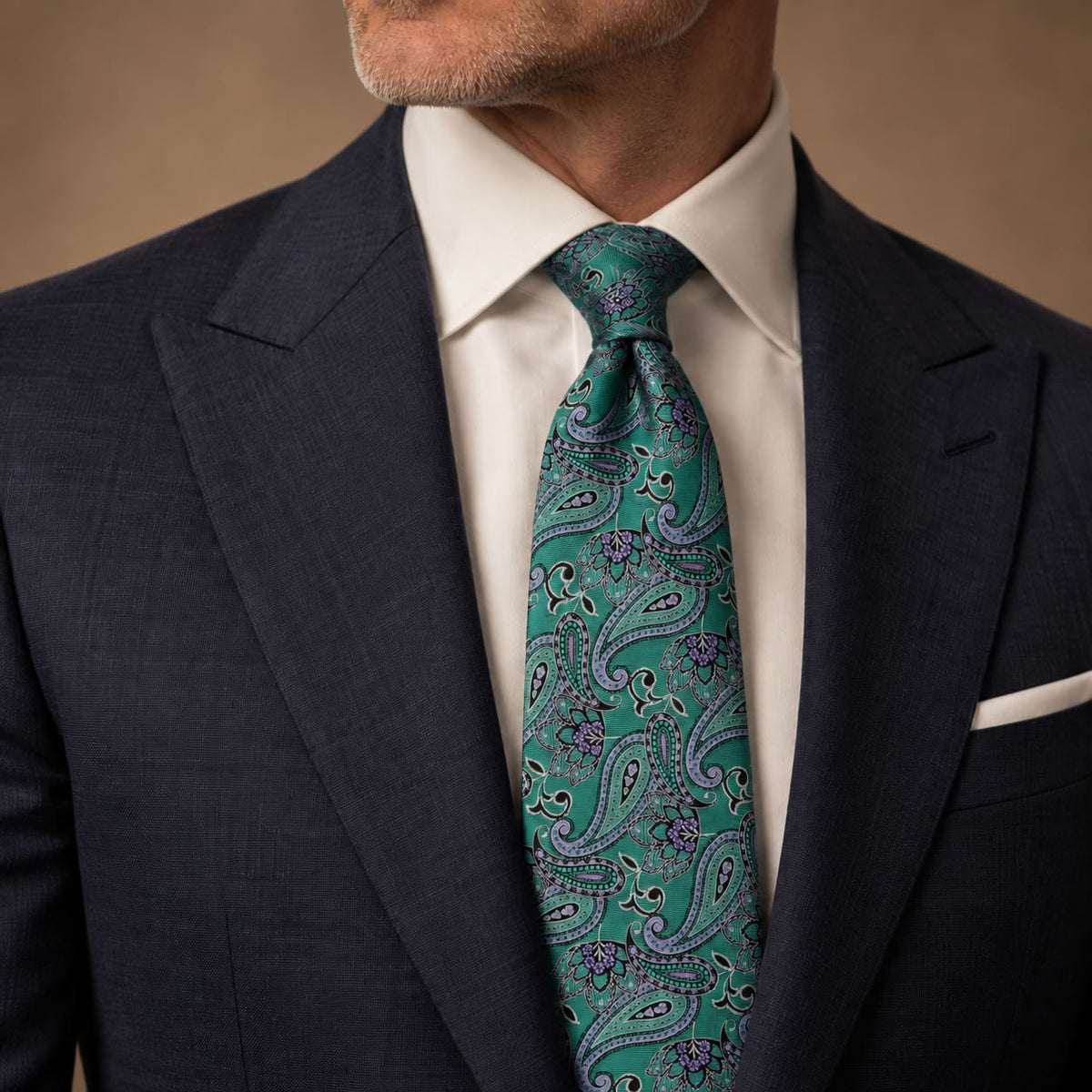Emerald and Purple Floral Silk Tie by George Neale, worn by a model with a suit and shirt