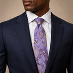 Purple and Gold Floral Silk Tie by George Neale, worn by a model with a suit and shirt