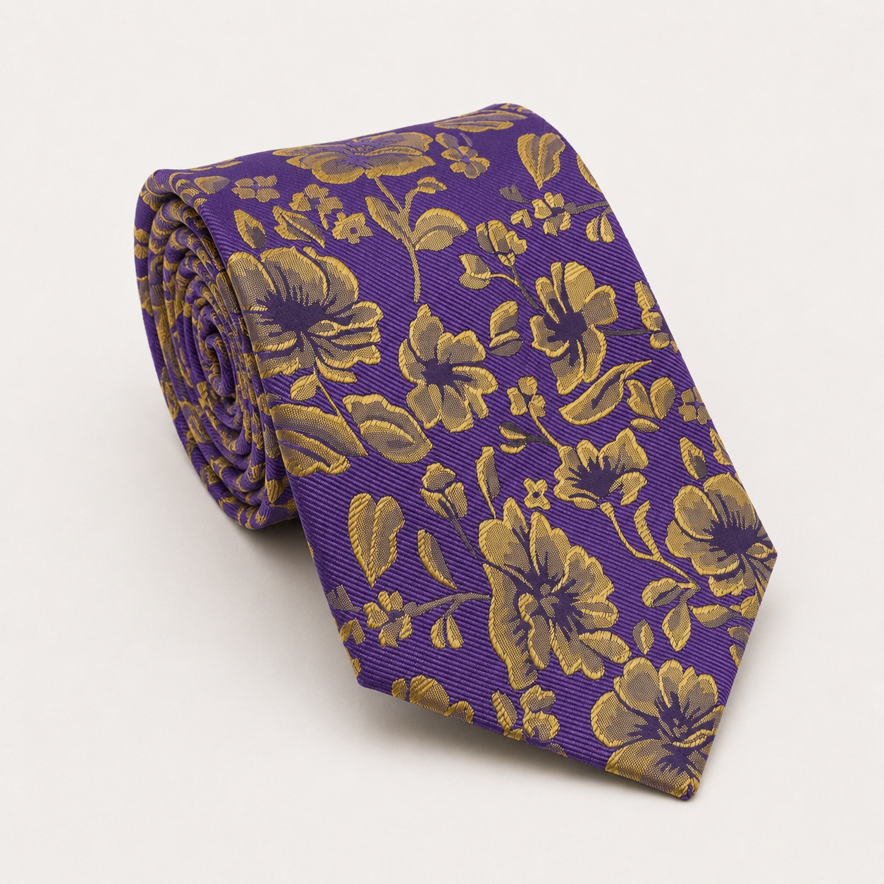 A rolled George Neale purple and gold floral silk tie.