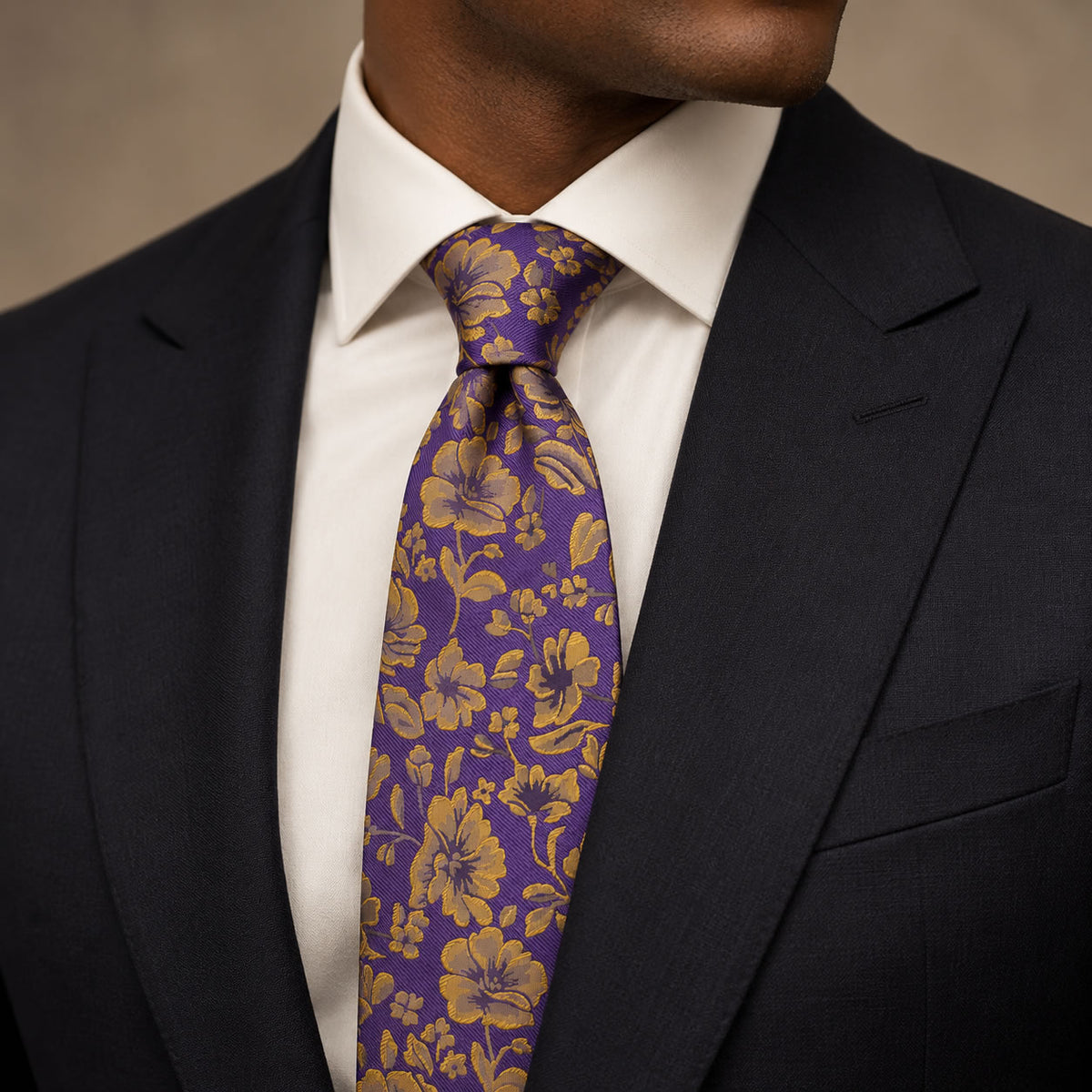 Purple and Gold Floral Silk Tie by George Neale, worn by a model with a suit and shirt