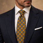 Gold and Blue Floral Silk Tie by George Neale, worn by a model with a suit and shirt