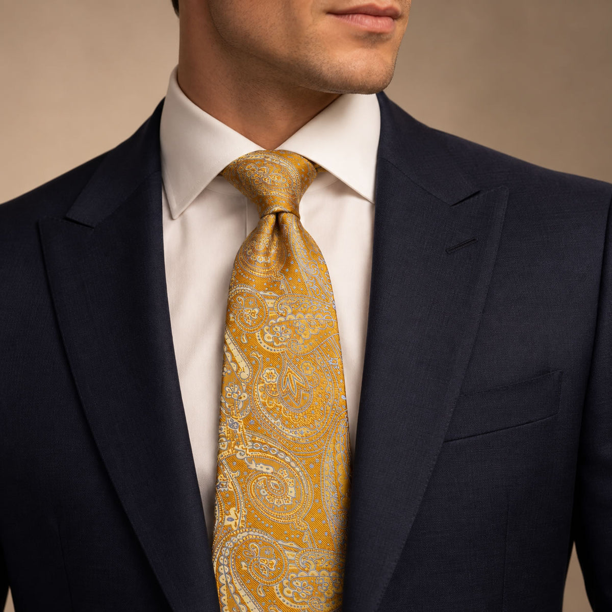 Dark Gold and Light Blue Floral Silk Tie by George Neale, worn by a model with a suit and shirt