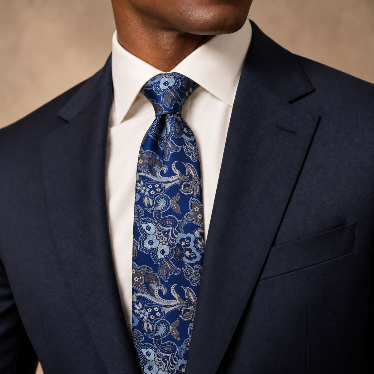 Navy and Silver Floral Silk Tie by George Neale, worn by a model with a suit and shirt