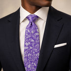Purple and Silver Floral Silk Tie by George Neale, worn by a model with a suit and shirt