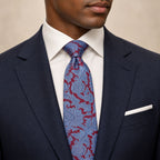 Maroon and Blue Floral Silk Tie by George Neale, worn by a model with a suit and shirt