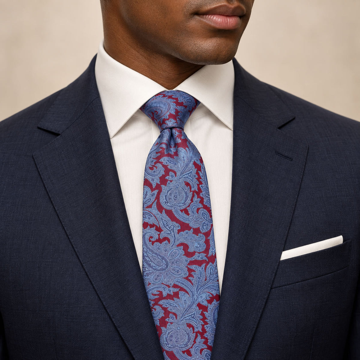 Maroon and Blue Floral Silk Tie by George Neale, worn by a model with a suit and shirt