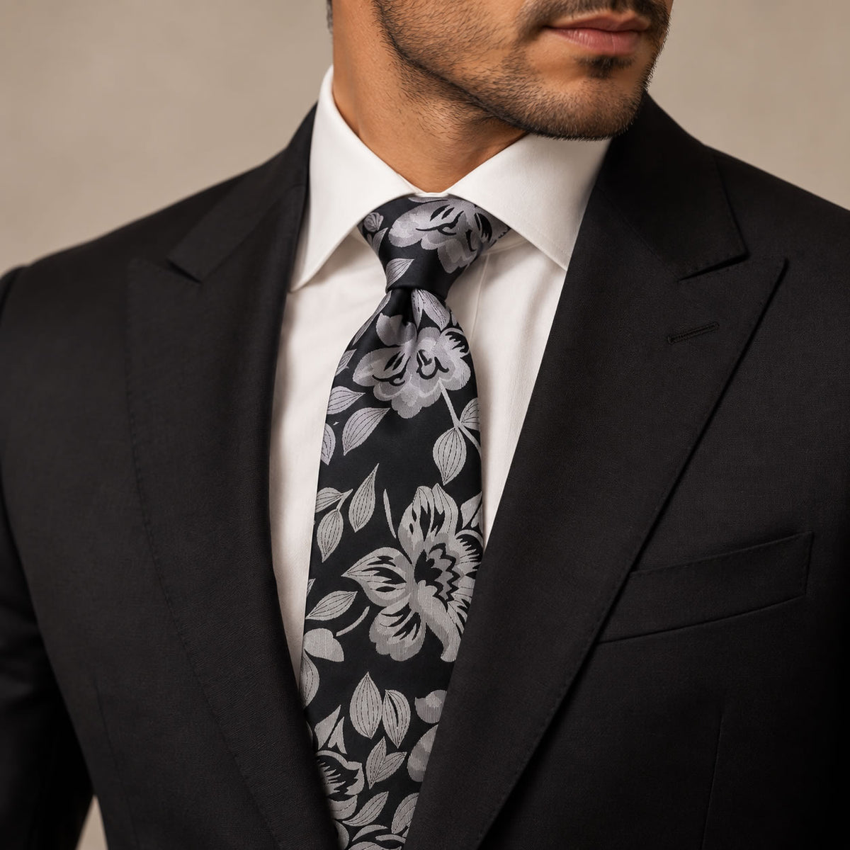 Black and Silver Floral Silk Tie by George Neale, worn by a model with a suit and shirt