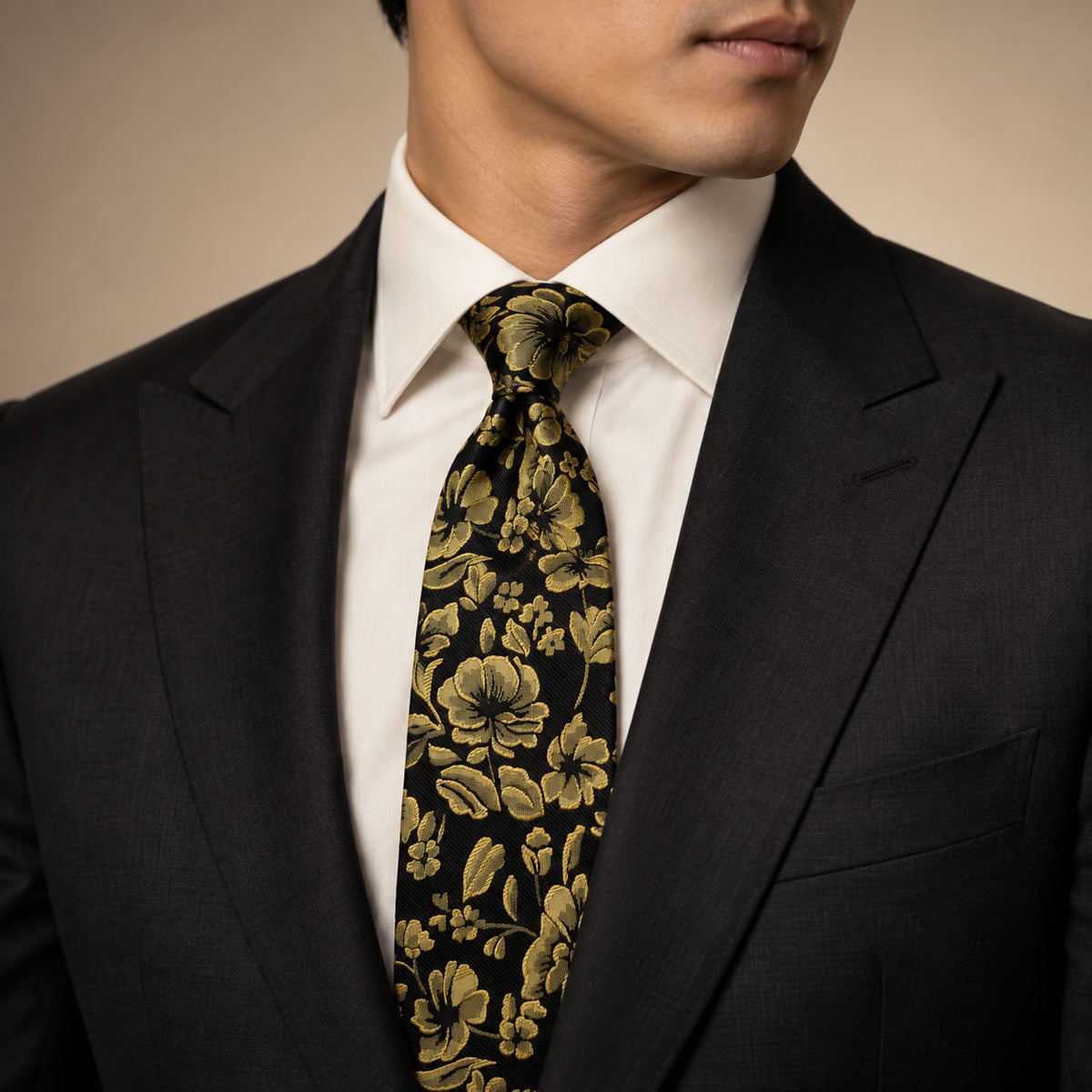 Black and Gold Floral Silk Tie by George Neale, worn by a model with a suit and shirt