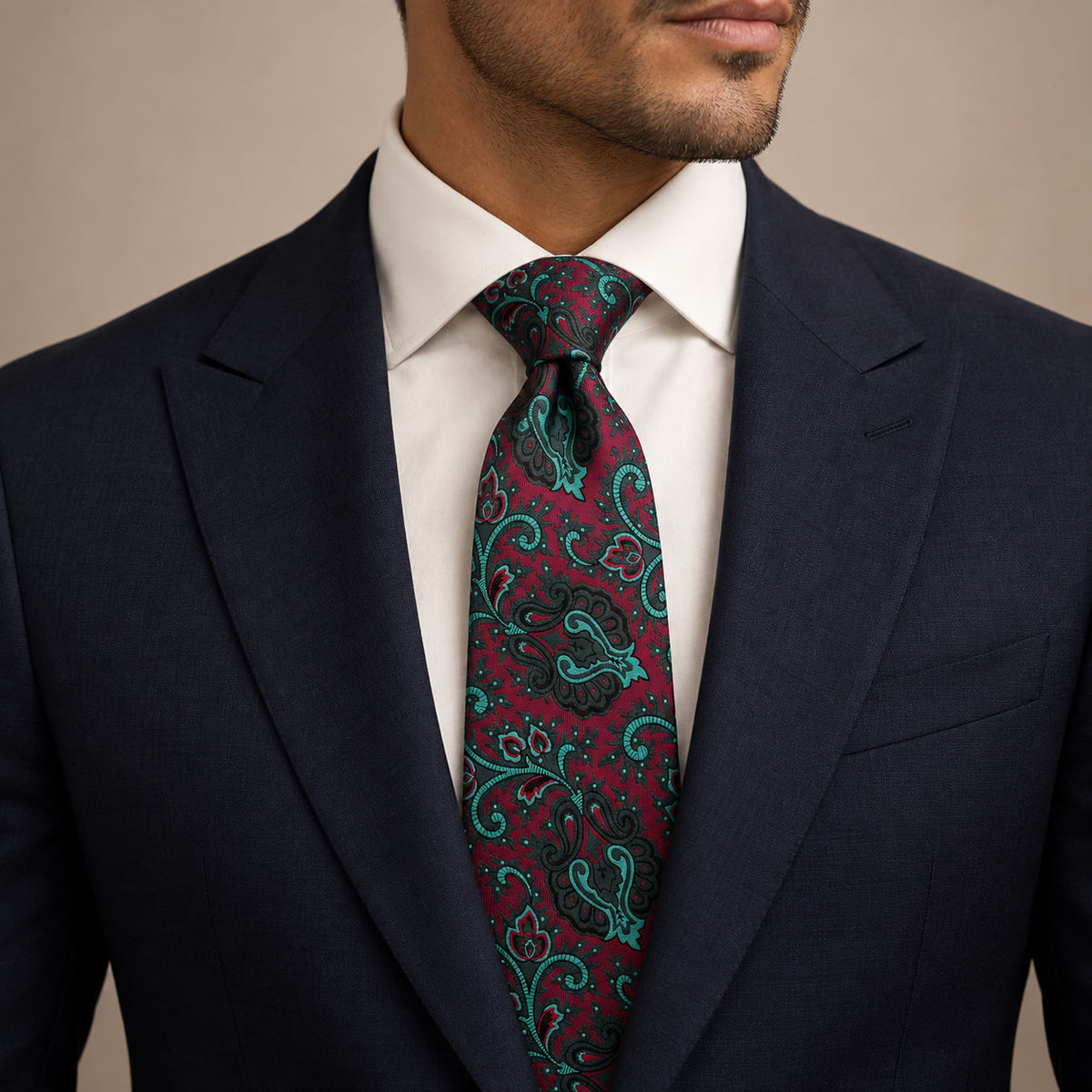 Burgundy and Emerald Floral Silk Tie by George Neale, worn by a model with a suit and shirt