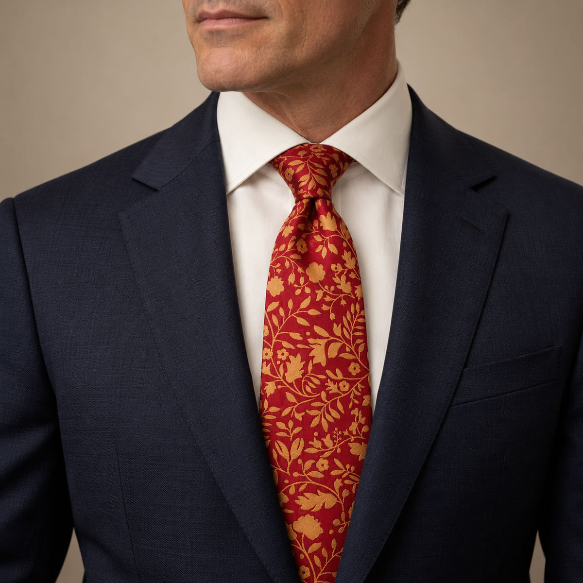 Red and Gold Floral Silk Tie by George Neale, worn by a model with a suit and shirt