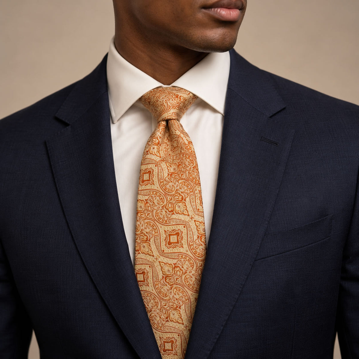 Orange and Champagne Floral Silk Tie by George Neale, worn by a model with a suit and shirt
