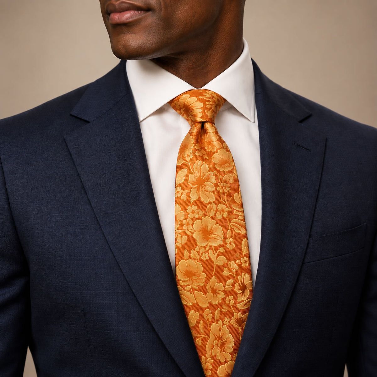 Orange and Gold Floral Silk Tie by George Neale, worn by a model with a suit and shirt
