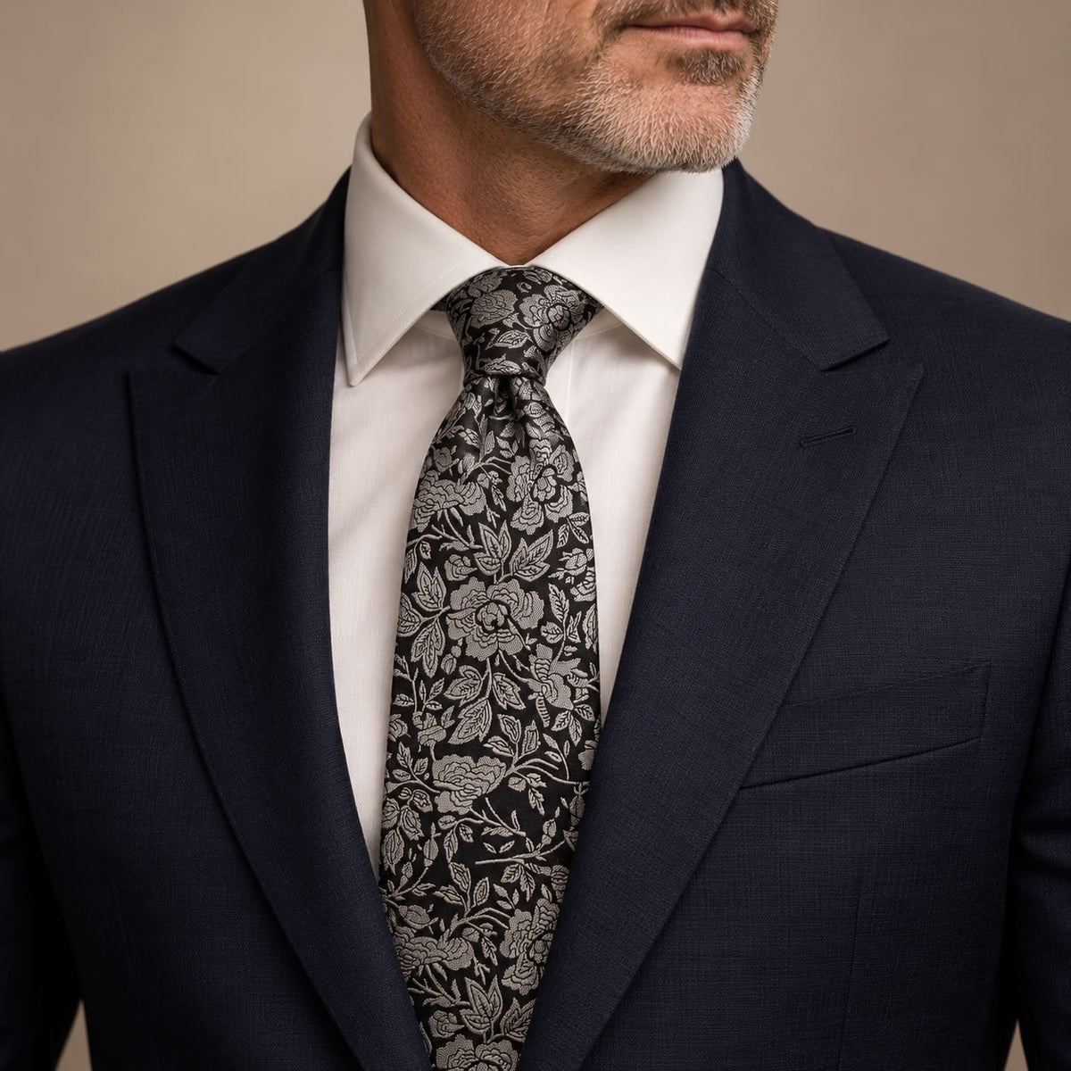 Black and Silver Floral Silk Tie by George Neale, worn by a model with a suit and shirt