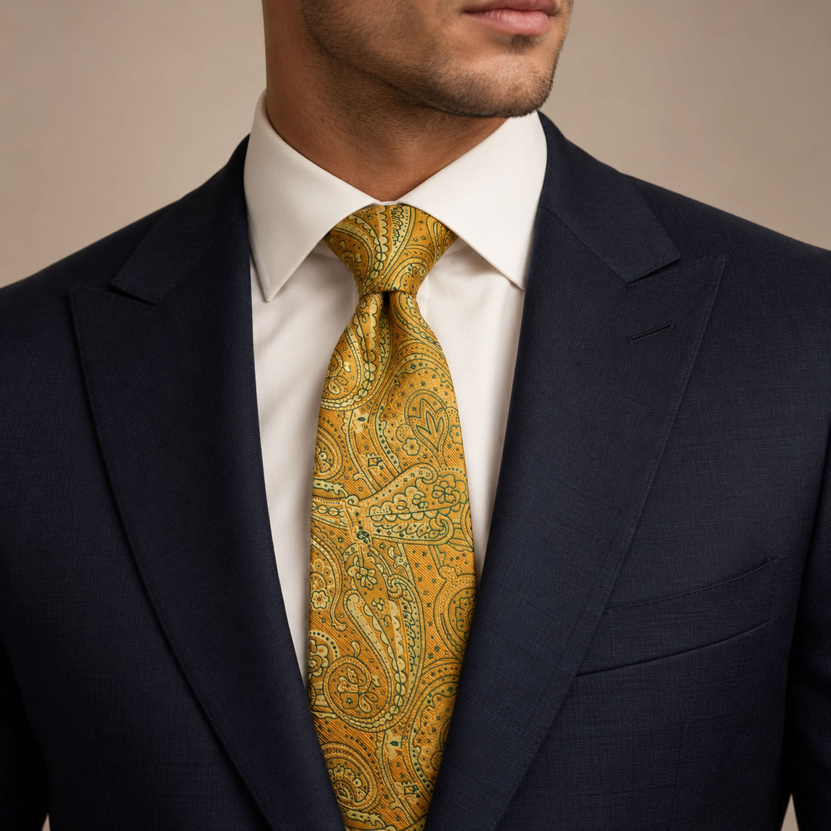 Gold and Green Floral Silk Tie by George Neale, worn by a model with a suit and shirt