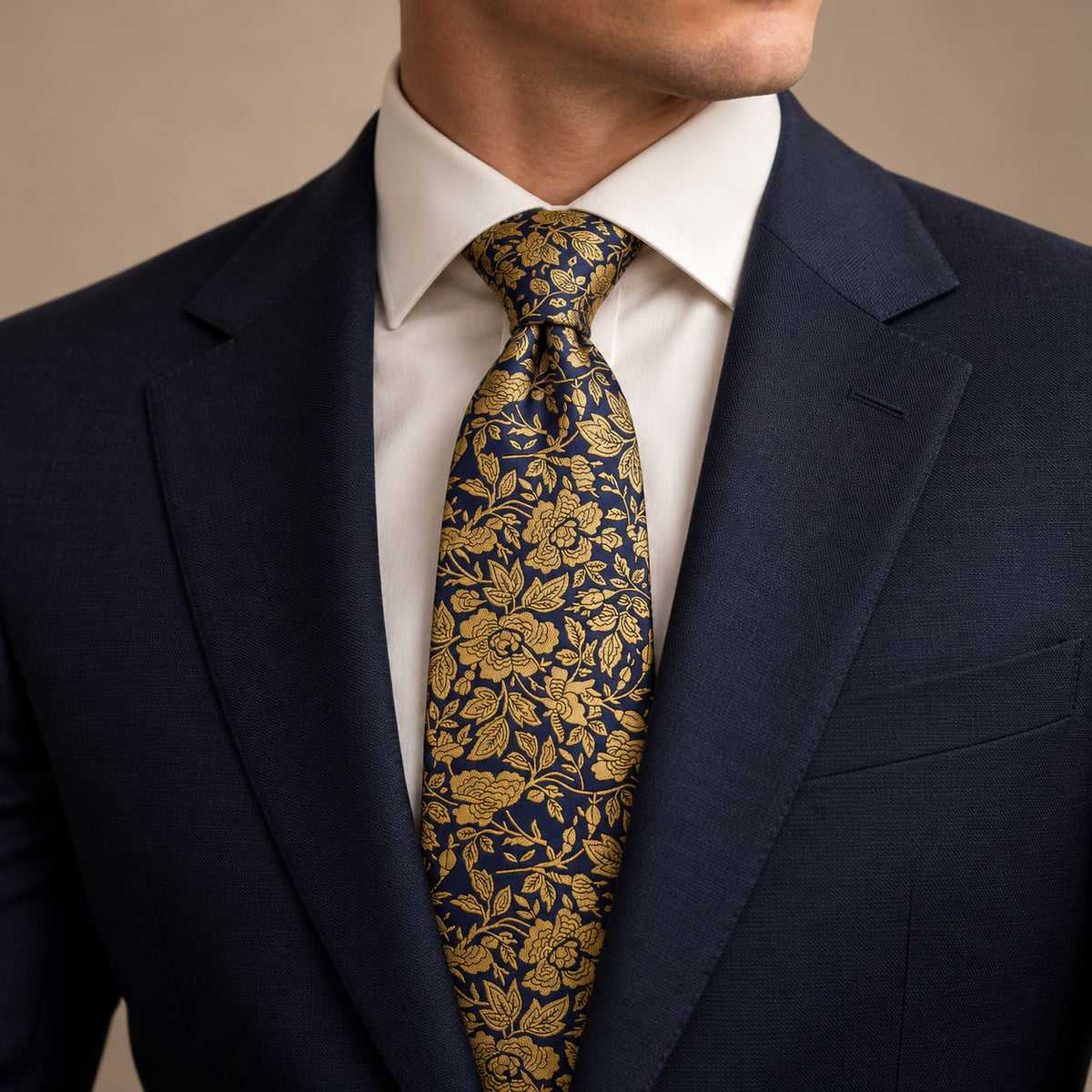 Navy and Gold Floral Silk Tie by George Neale, worn by a model with a suit and shirt