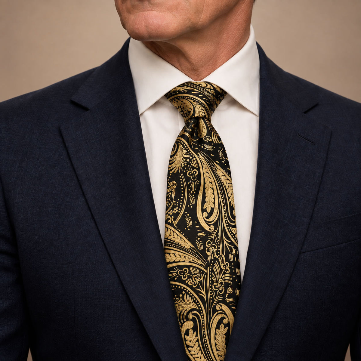 Black and Gold Floral Silk Tie by George Neale, worn by a model with a suit and shirt