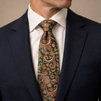 Green and Orange Floral Silk Tie by George Neale, worn by a model with a suit and shirt