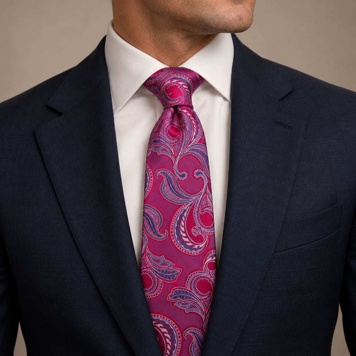 Fuchsia and Purple Floral Silk Tie by George Neale, worn by a model with a suit and shirt