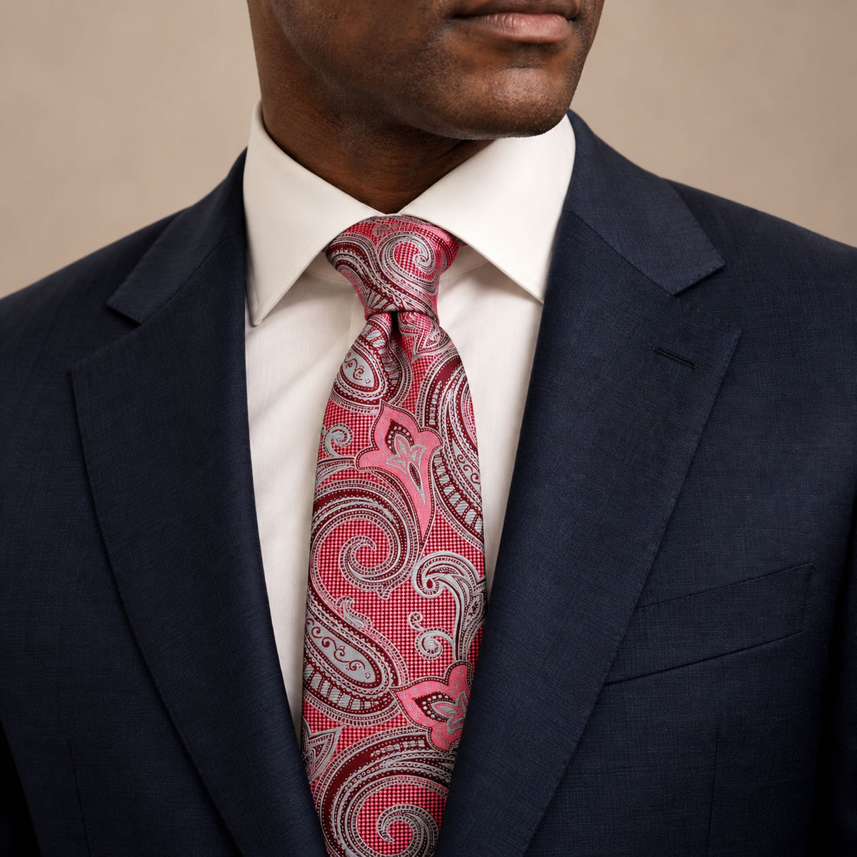 Burgundy and Teal Floral Silk Tie by George Neale, worn by a model with a suit and shirt