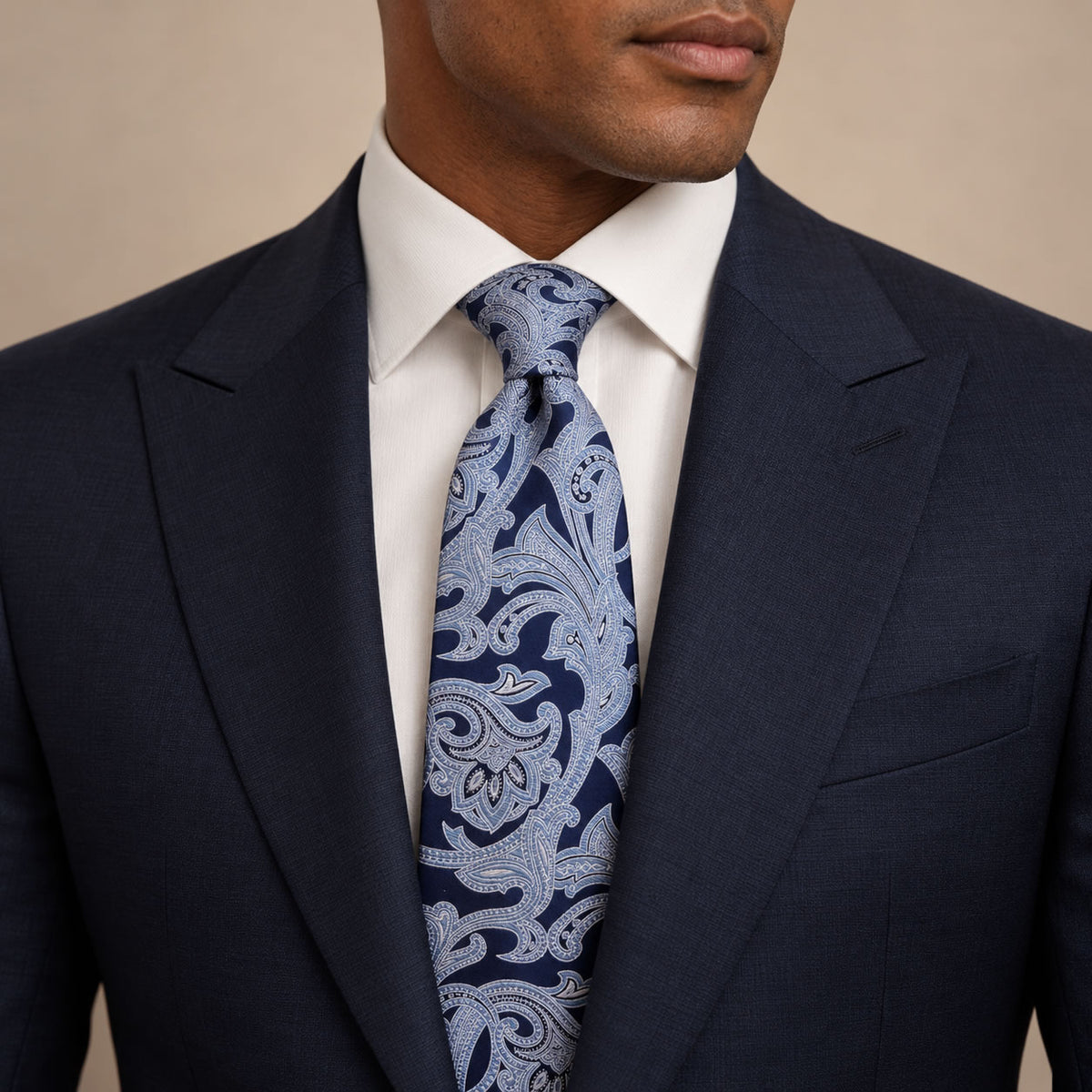 Navy and Light Blue Floral Silk Tie by George Neale, worn by a model with a suit and shirt