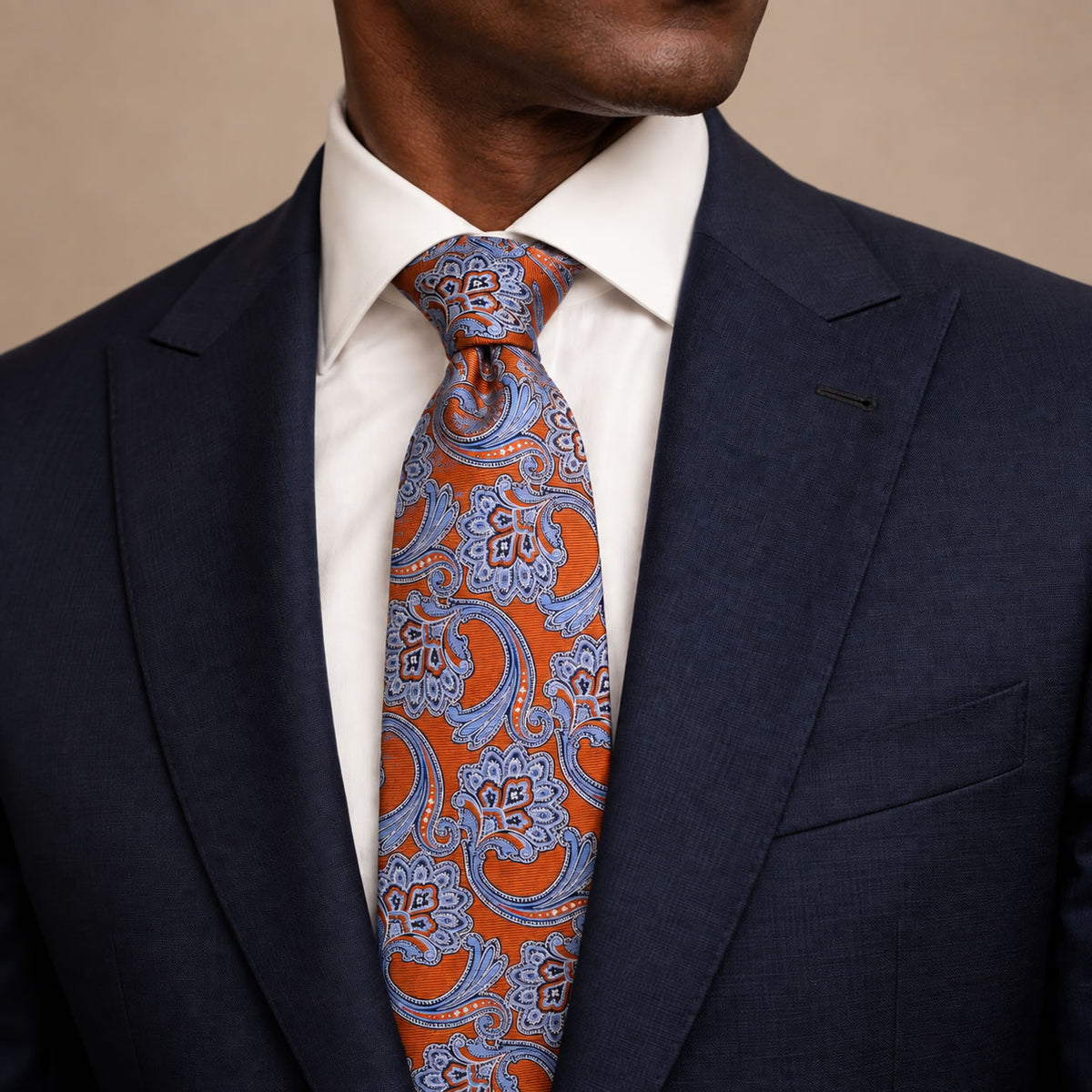 Rust Red and Light Blue Floral Silk Tie by George Neale, worn by a model with a suit and shirt