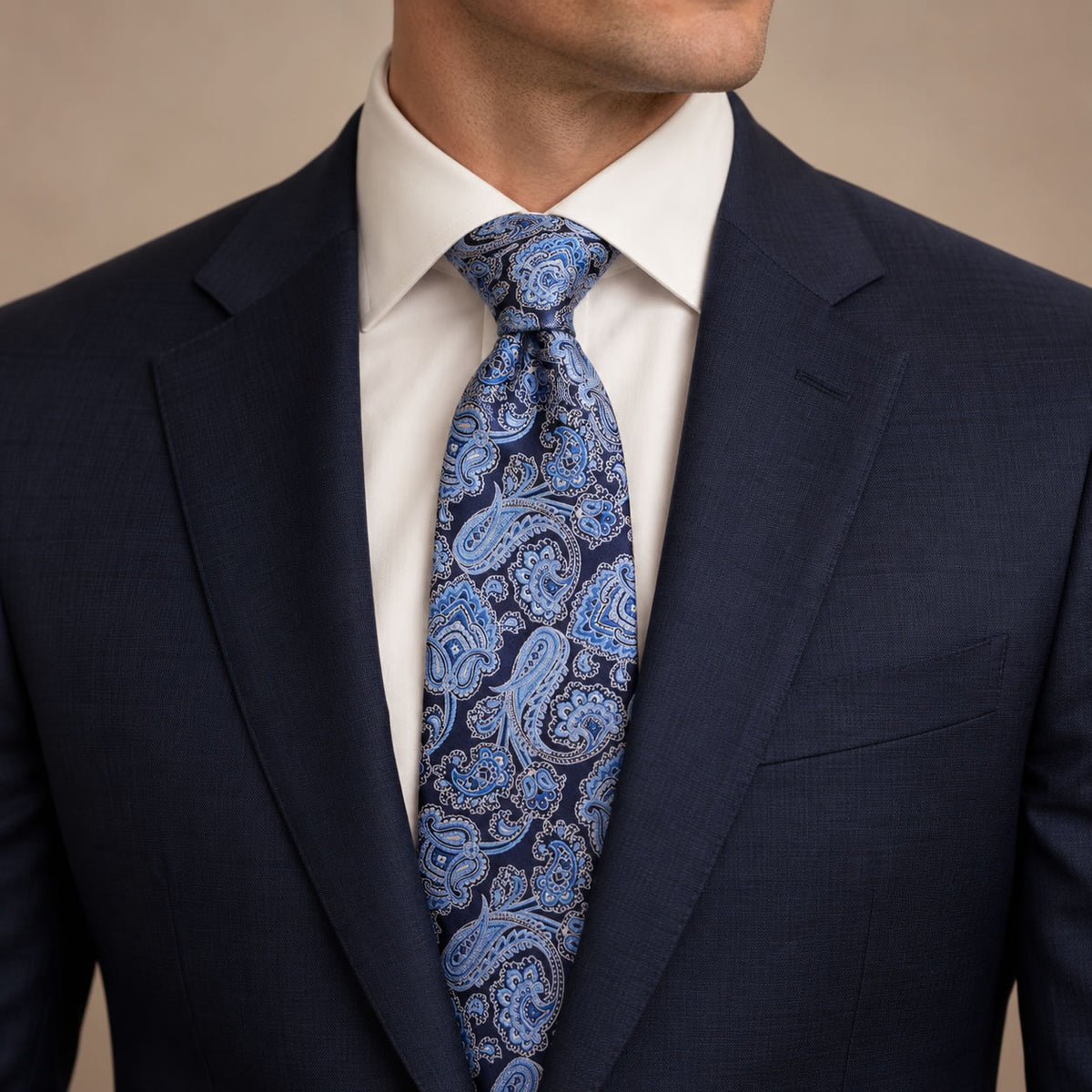 Navy and Light Blue Floral Silk Tie by George Neale, worn by a model with a suit and shirt