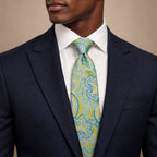Green and Blue Floral Silk Tie by George Neale, worn by a model with a suit and shirt