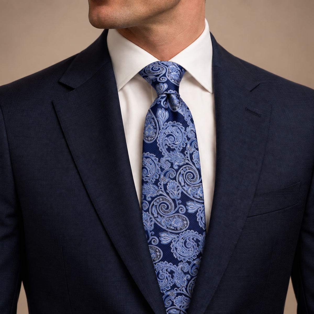 Navy and Blue Floral Silk Tie by George Neale, worn by a model with a suit and shirt