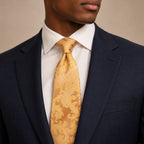 Champagne Floral Silk Tie by George Neale, worn by a model with a suit and shirt