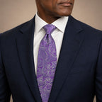 Violet Floral Silk Tie by George Neale, worn by a model with a suit and shirt